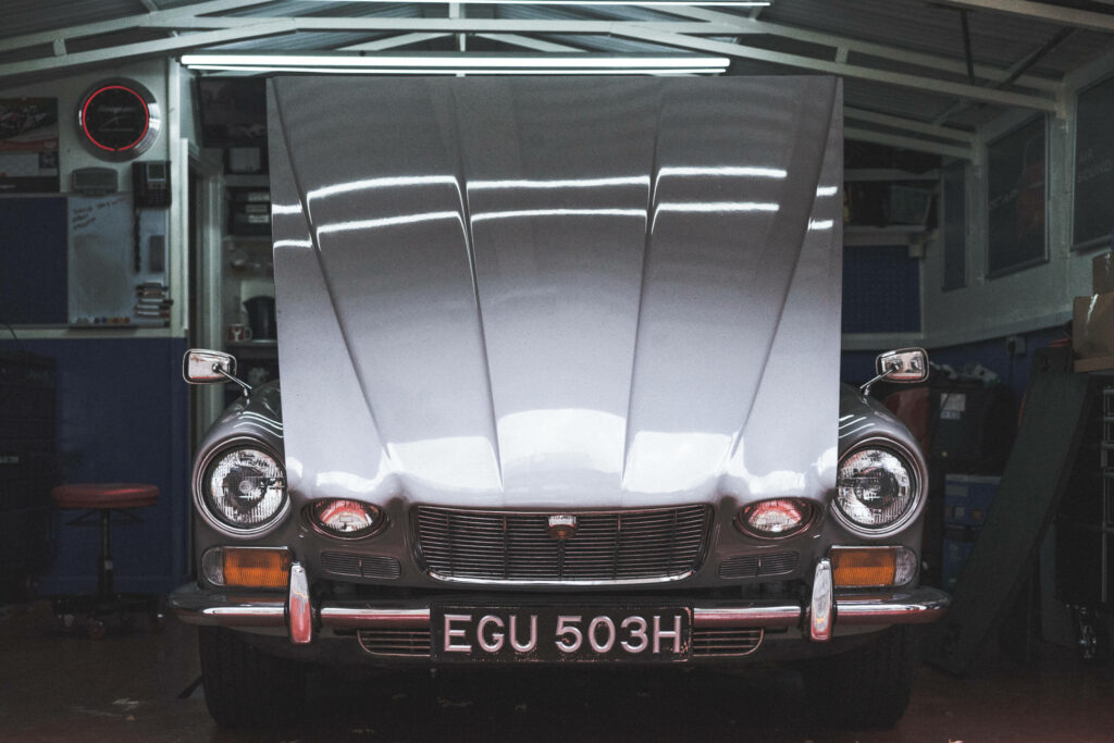 Pristine Classic Automobile Undergoing Maintenance in Nostalgic Setting Wallpaper