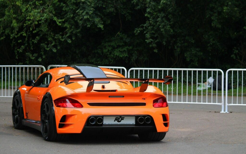 Sleek Orange RUF Sports Car Wallpaper with Lush Green Background