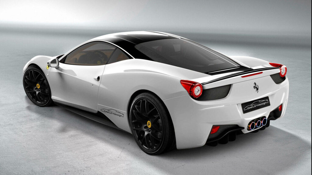 The Iconic Ferrari: A Stunning Rear View of a White Sports Car with Triple Exhaust and Legendary Emblem in a Captivating Backdrop Wallpaper