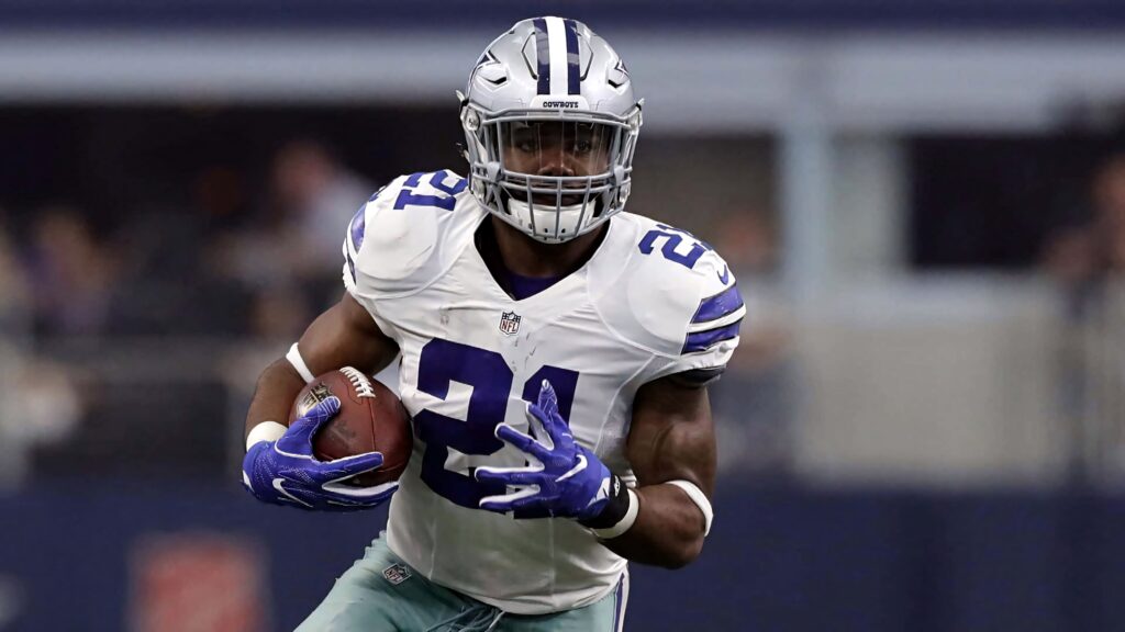 Ezekiel Elliott Dallas Cowboys running back mid-action high resolution stadium wallpaper background
