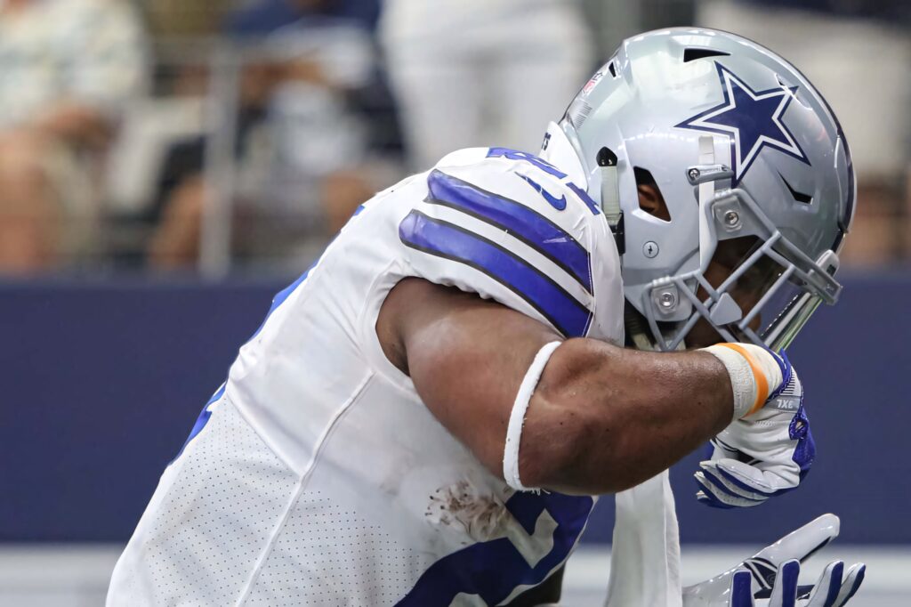 Ezekiel Elliott Dallas Cowboys running back in white blue uniform with silver helmet in action Wallpaper