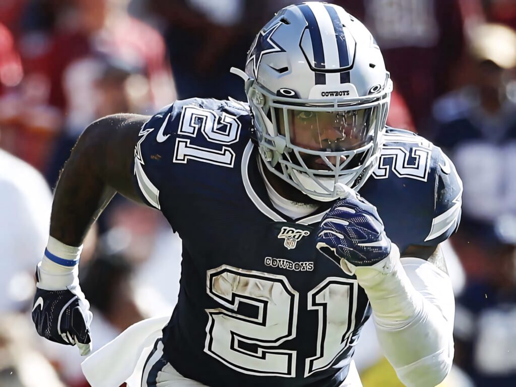 Ezekiel Elliott Dallas Cowboys running back in action wearing navy silver uniform dynamic football wallpaper