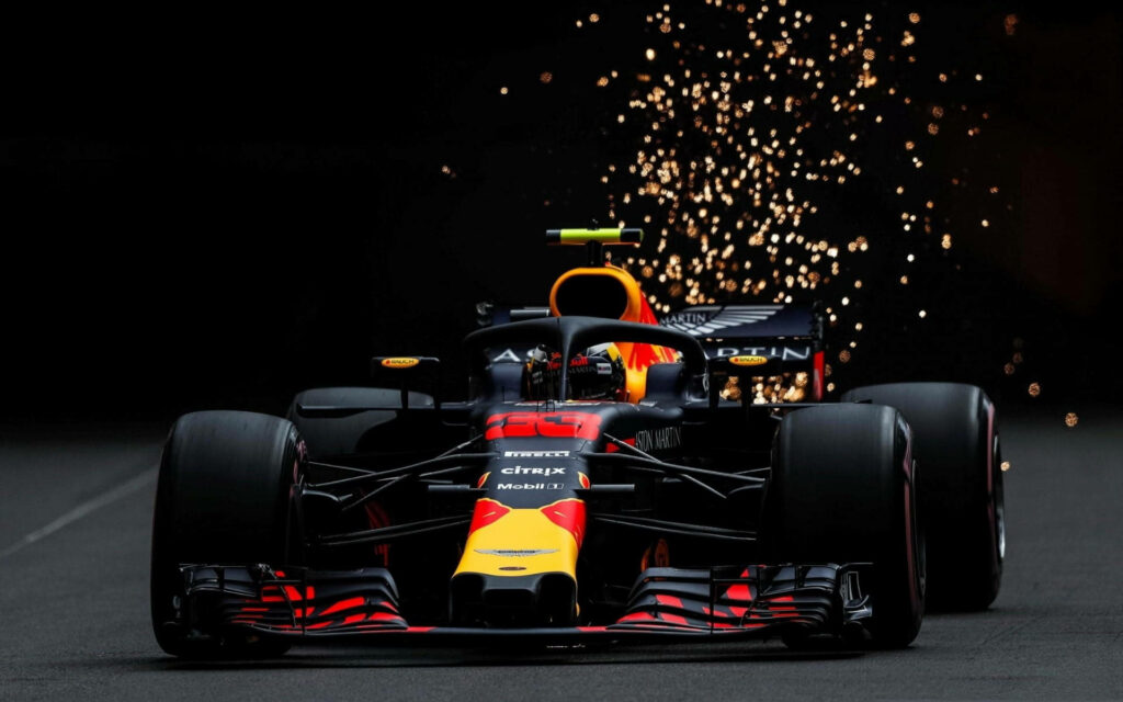 Red Bull Racing F1 car speeding on track with dynamic sparks thrilling Formula 1 racing wallpaper