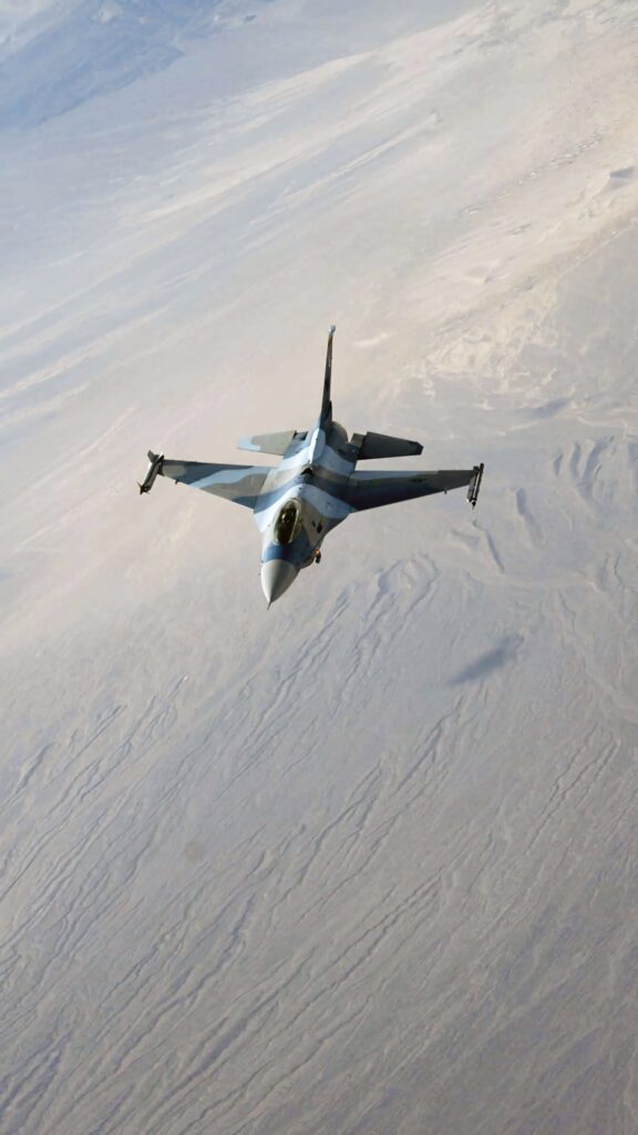 General Dynamics F16 Fighting Falcon jet soaring over arid desert showcasing speed and agility Wallpaper