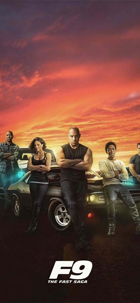 F9 Fast Saga wallpaper with Vin Diesel and team by muscle cars at fiery orange sunset background