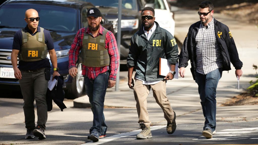 FBI agents in tactical gear walking on sunny street intense professional crime drama wallpaper