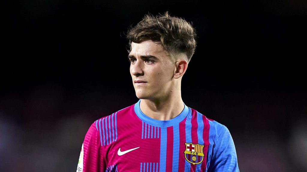 FC Barcelona star Gavi in red blue kit focused intense football wallpaper background