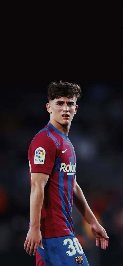 FC Barcelona Gavi focused in red and blue kit number 30 stadium lighting sports wallpaper