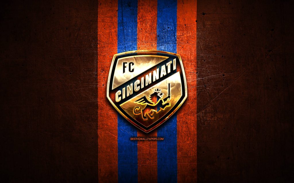 FC Cincinnati wallpaper with golden winged lion crest on rugged blue and orange stripes background