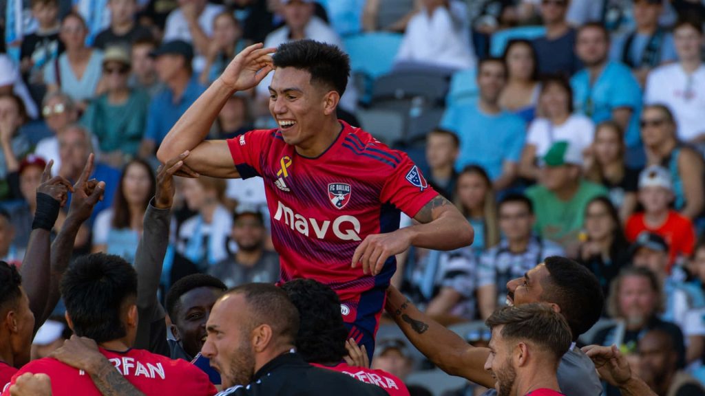 FC Dallas Alan Velasco joyful celebration lifted by teammates red soccer team unity wallpaper