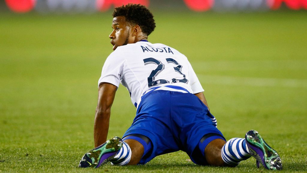 FC Dallas midfielder Kellyn Acosta number 23 resting on pitch during MLS match vs Houston Dynamo Wallpaper