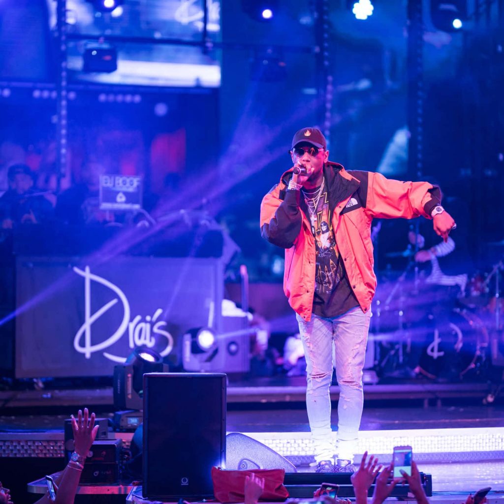 Rapper Fabolous performing live at Drais in orange jacket blue stage lights concert wallpaper