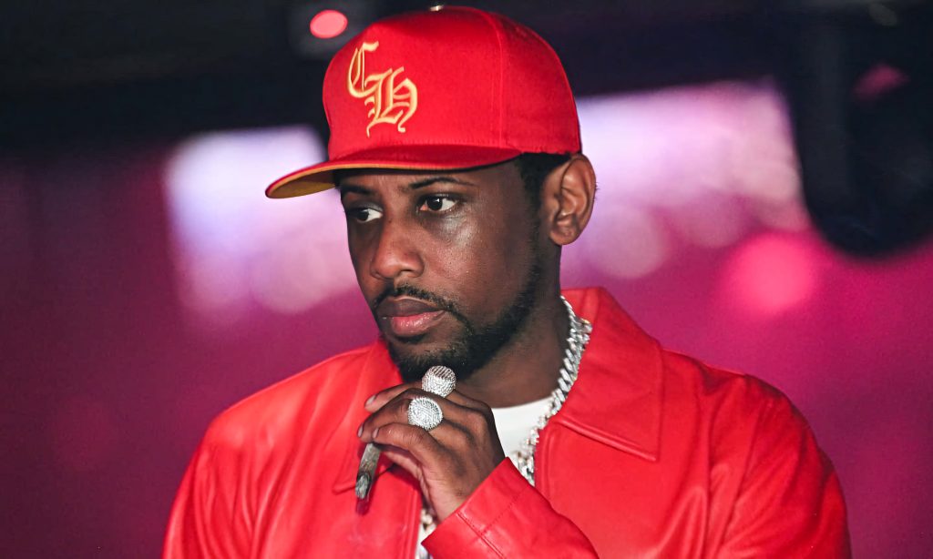 Rapper Fabolous in red cap and jacket with diamond rings and silver chain holding blunt wallpaper
