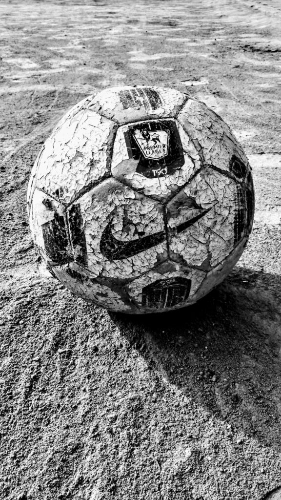 Vintage Grayscale Football on Sand - HD Wallpaper for Sports Enthusiasts