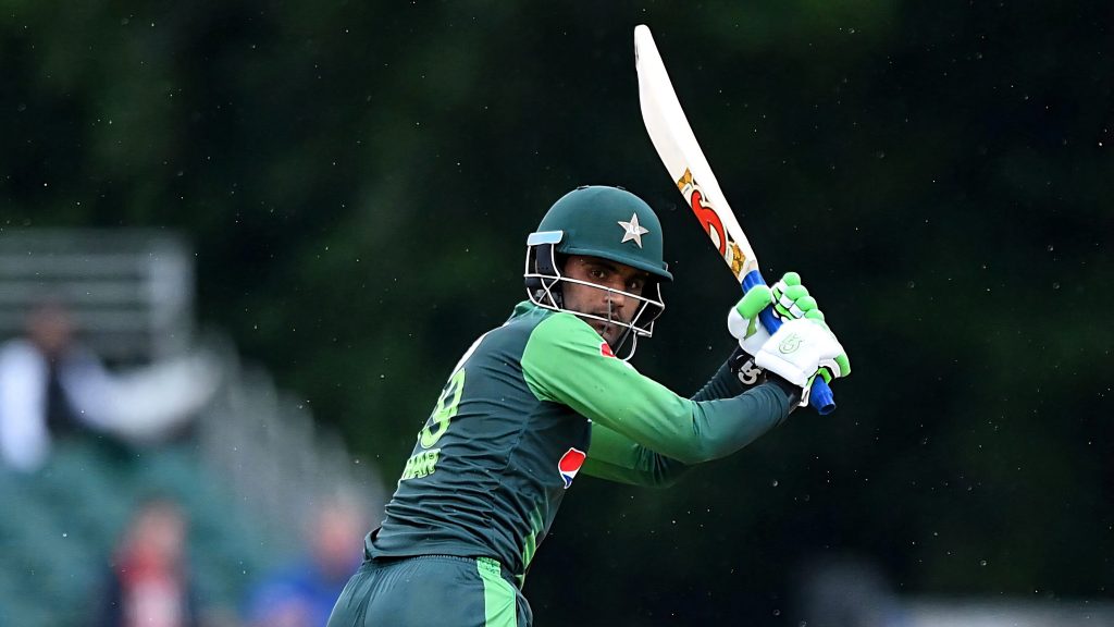 Fakhar Zaman Pakistan cricket batsman poised to strike in dark green kit with star helmet Wallpaper