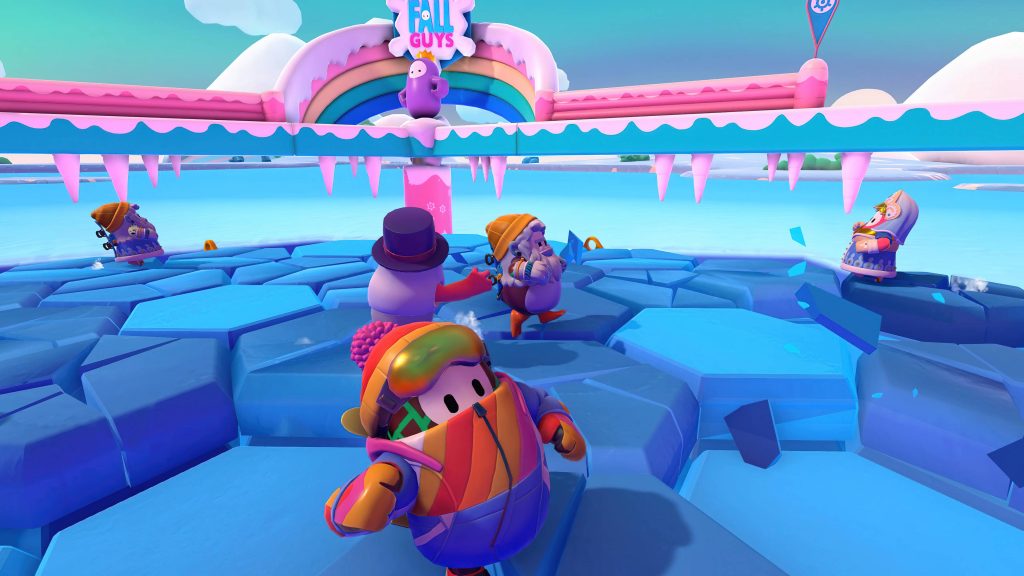 Fall Guys ice arena battle with vibrant winter gear beans on breaking hexagonal ice tiles Wallpaper