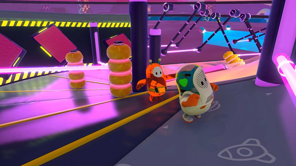 Fall Guys neon Slimescraper level with orange alien and white cyborg beans racing on dark track Wallpaper