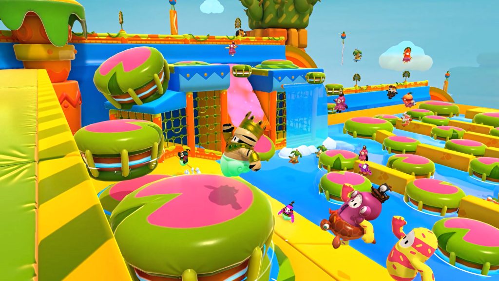 Fall Guys Treetop Tumble wallpaper with colorful jellybean characters bouncing on lily pads