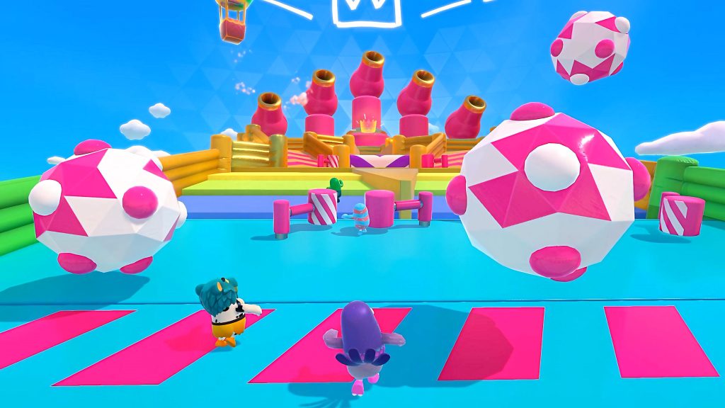 Fall Guys colorful beans dodge giant pink and white balls in vibrant bouncing ball level wallpaper