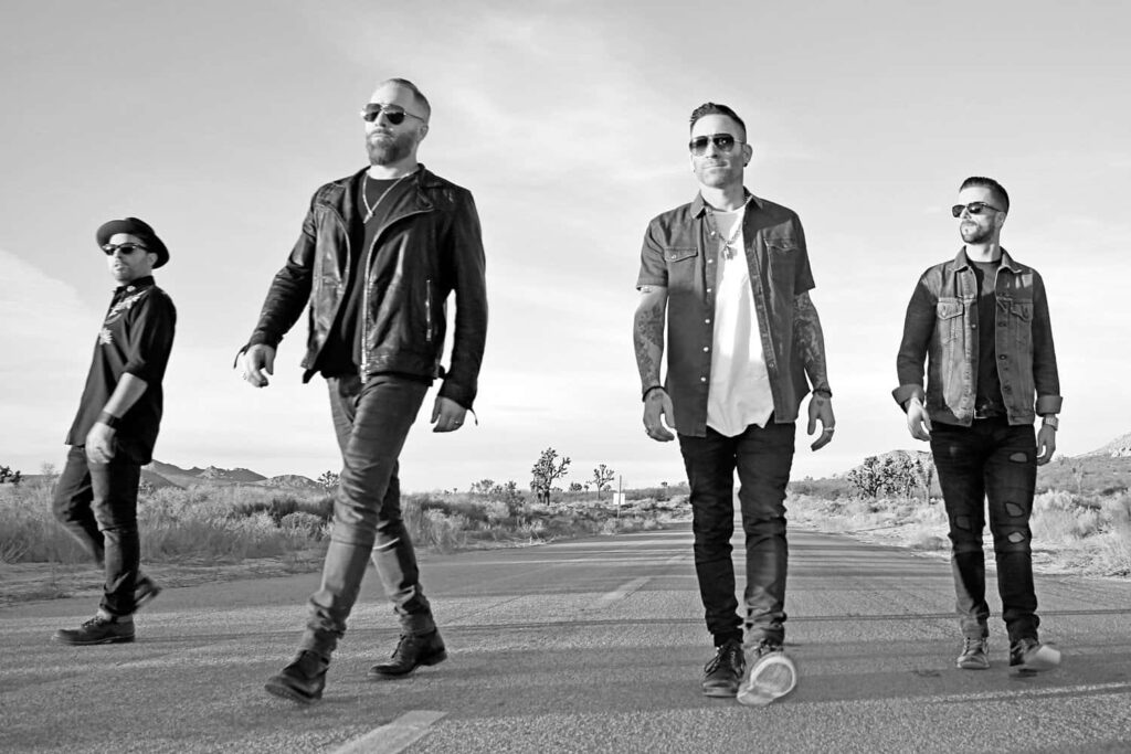 Fall Out Boy walking down open road dynamic wallpaper showcasing rebellious modern rock energy