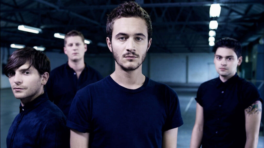 Young Fall Out Boy members pose in dim room moody wallpaper capturing edgy band vibe
