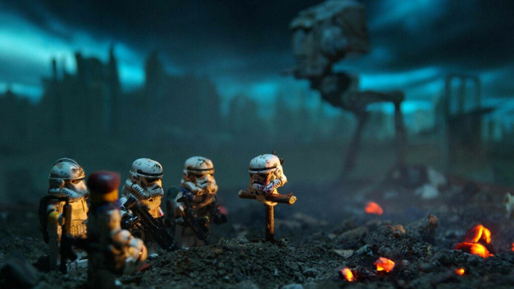 Grief-stricken Lego Stormtroopers Pay Tribute to Fallen Companion in Embers' Glow Wallpaper