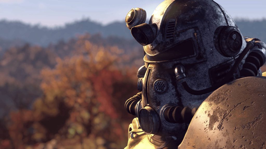 Close-up of battle-worn T-51 Power Armor helmet in autumn Appalachian forest Fallout 76 wallpaper