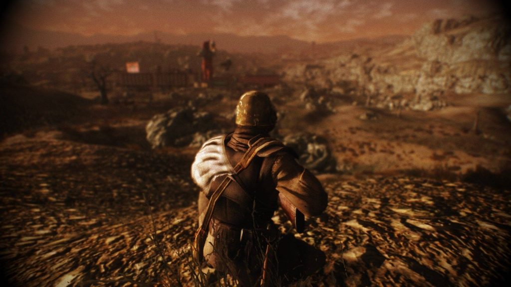 Fallout New Vegas Courier in Ranger helmet overlooks sepia Mojave wasteland warzone wallpaper