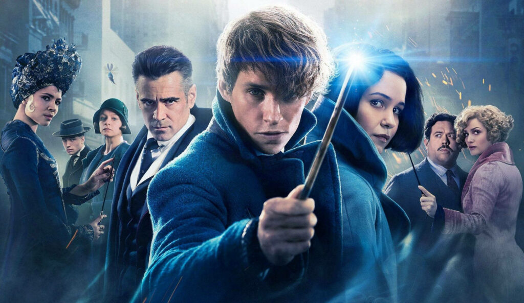 Fantastic Beasts poster with Newt Scamander wand raised and key characters city background wallpaper