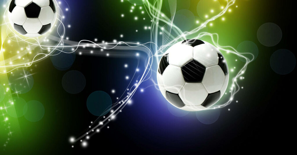 Enchanted Soccer: an Artful Display of Magical White and Black Balls Surrounded by Vibrant Bokeh and Sparkles Wallpaper