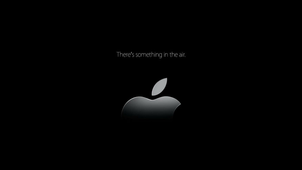 The Intriguing Half-Cut Apple Logo: Mesmerizing 4k Image With Text on Black Background Wallpaper