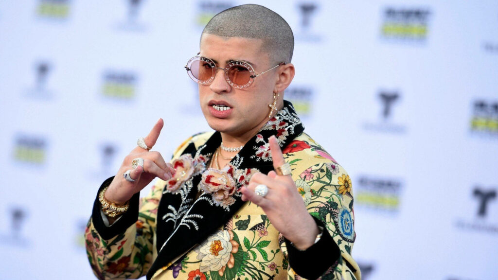 Rockstar Vibes: Bad Bunny's Stylish Floral Coat and Pink Glasses Essence Wallpaper