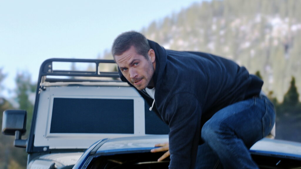 Speeding into Action: Paul Walker's Iconic Stance in Fast and Furious 7 - Mesmerizing 4K Wallpaper Snapshot