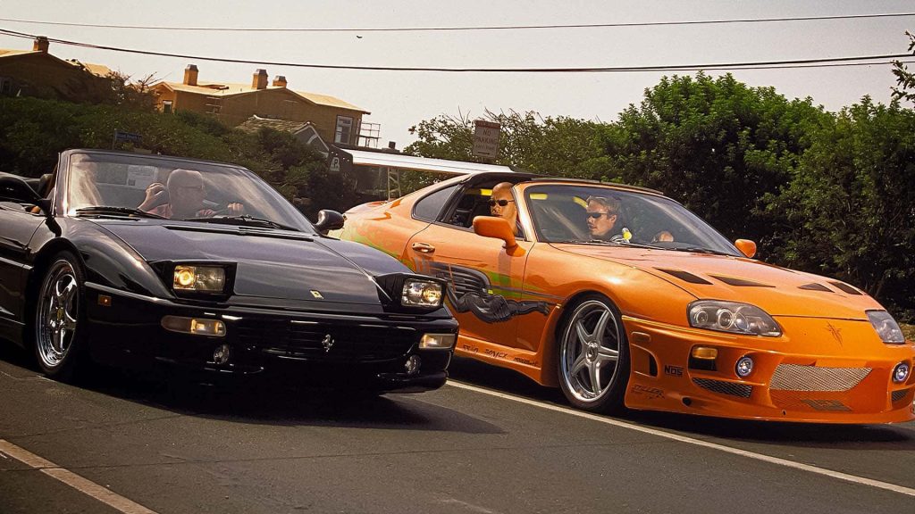 Fast and Furious street race Brian OConner orange Toyota Supra and Dominic Toretto black Ferrari wallpaper