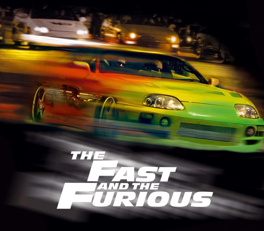 Fast and Furious Toyota Supra racing at night with motion blur and bold white logo wallpaper