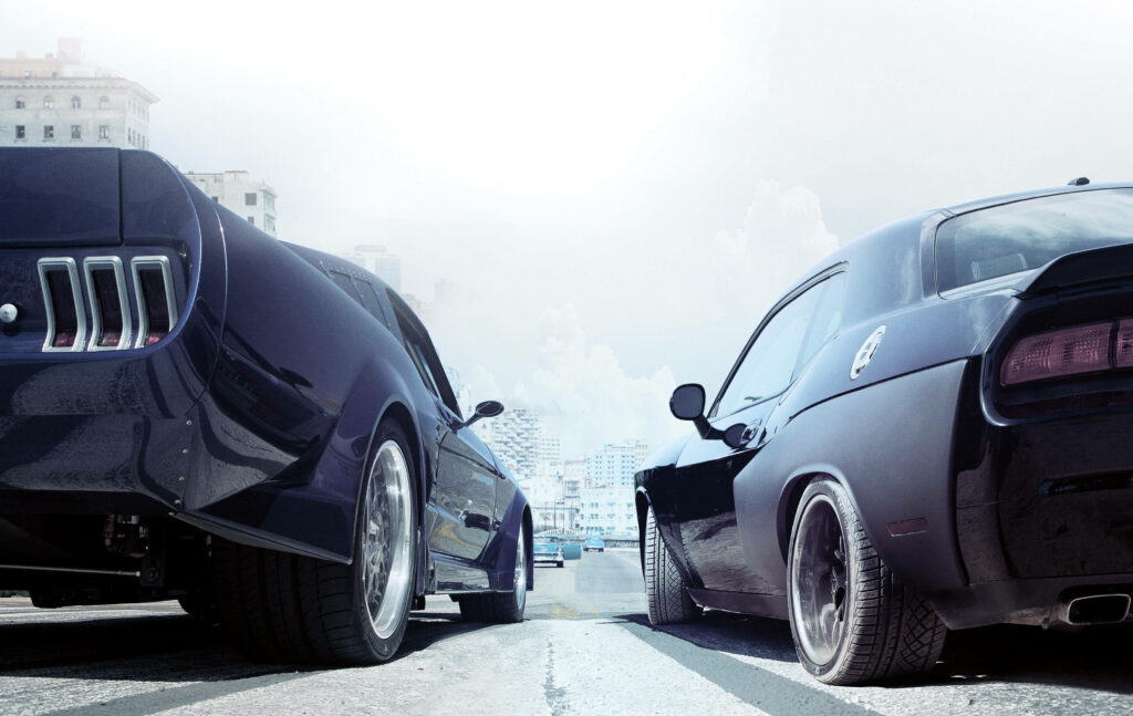 Two Fast and Furious cars lined up on city street with intense high speed racing atmosphere wallpaper