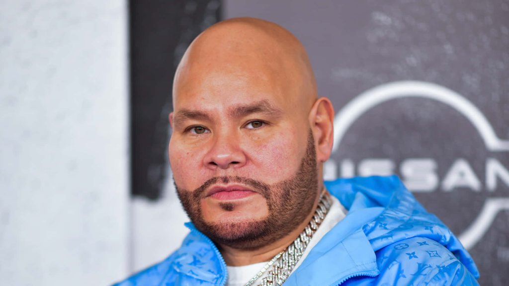 High-resolution portrait of rapper Fat Joe in light blue monogram jacket with silver chain Wallpaper