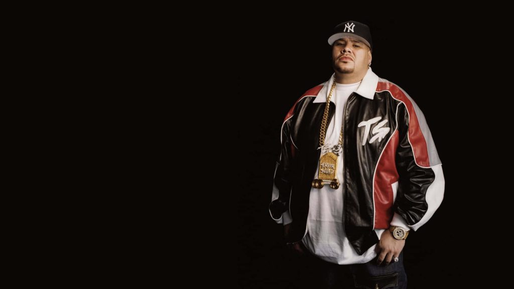 High-resolution studio portrait of Fat Joe wearing Terror Squad jacket and Yankees cap Wallpaper