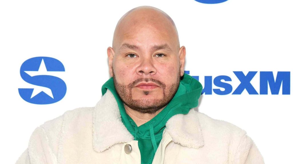 Portrait of rapper Fat Joe in green hoodie and cream jacket at SiriusXM event background wallpaper