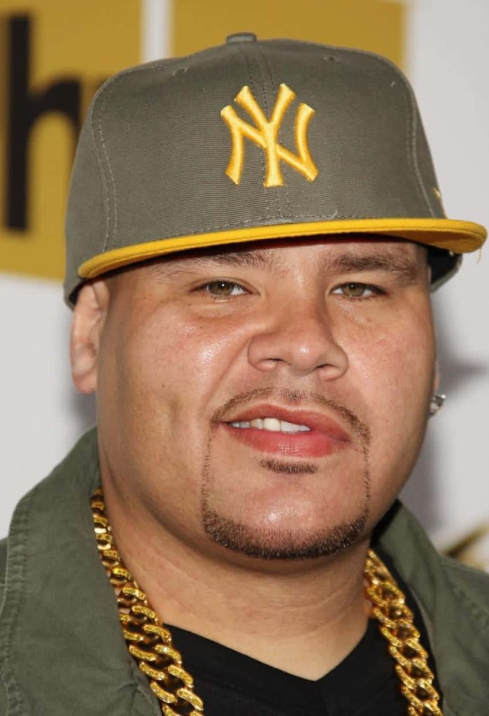 Close-up portrait of rapper Fat Joe wearing New York Yankees cap and gold chain hip-hop style wallpaper