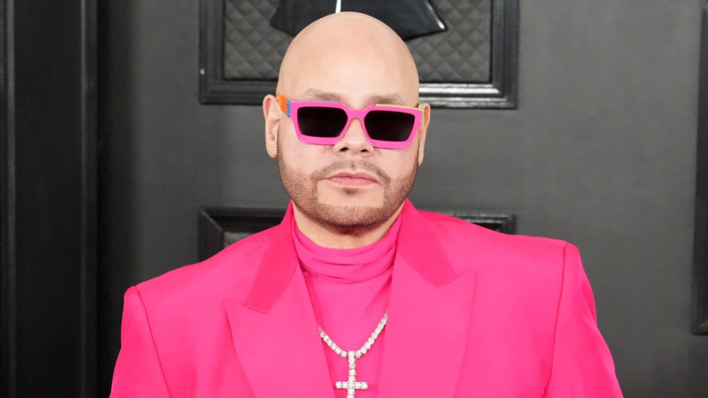 Fat Joe in bold pink suit and sunglasses with diamond cross pendant vibrant rapper wallpaper