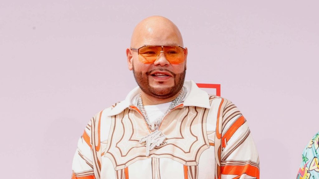 Fat Joe portrait with orange glasses patterned jacket silver chain pink background wallpaper