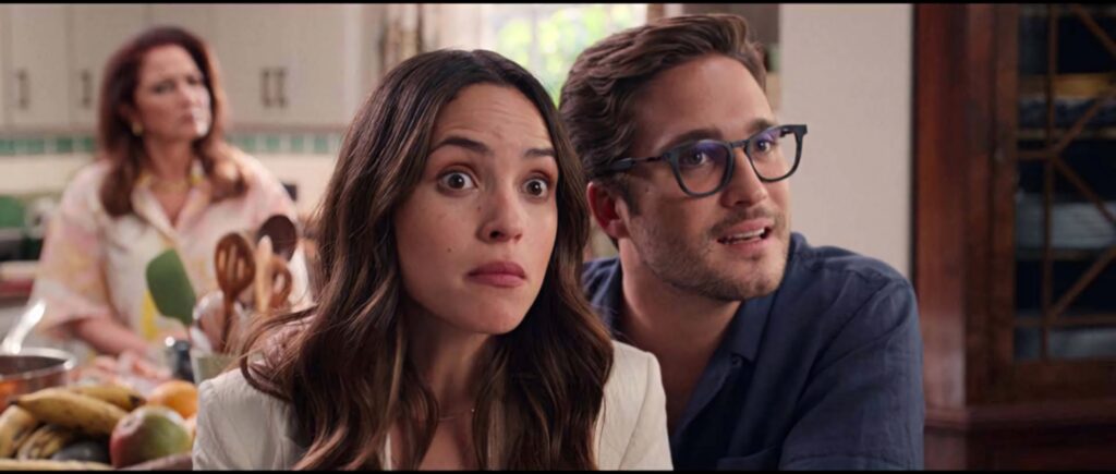 Lively Father Of The Bride kitchen scene with young couple and concerned woman in background Wallpaper