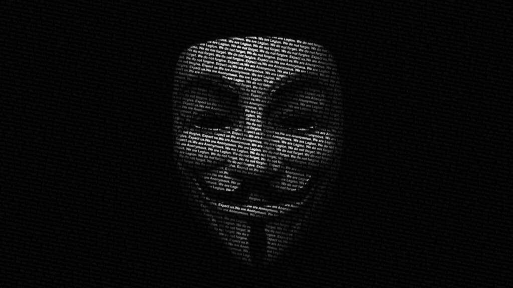 Digital Miscreant: A High-Resolution Cyberspace Composition featuring Hackers in Fawkes Masks on a Dark Background Wallpaper