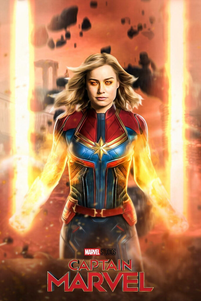 Powerful Captain Marvel: Brie Larson's Carol Danvers Strikes a Fierce Pose with Mysterious Floating Rocks in the Background Wallpaper