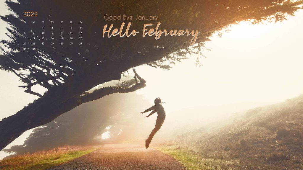 February 2022 calendar wallpaper joyful person leaping sunlit misty path under large tree nature background