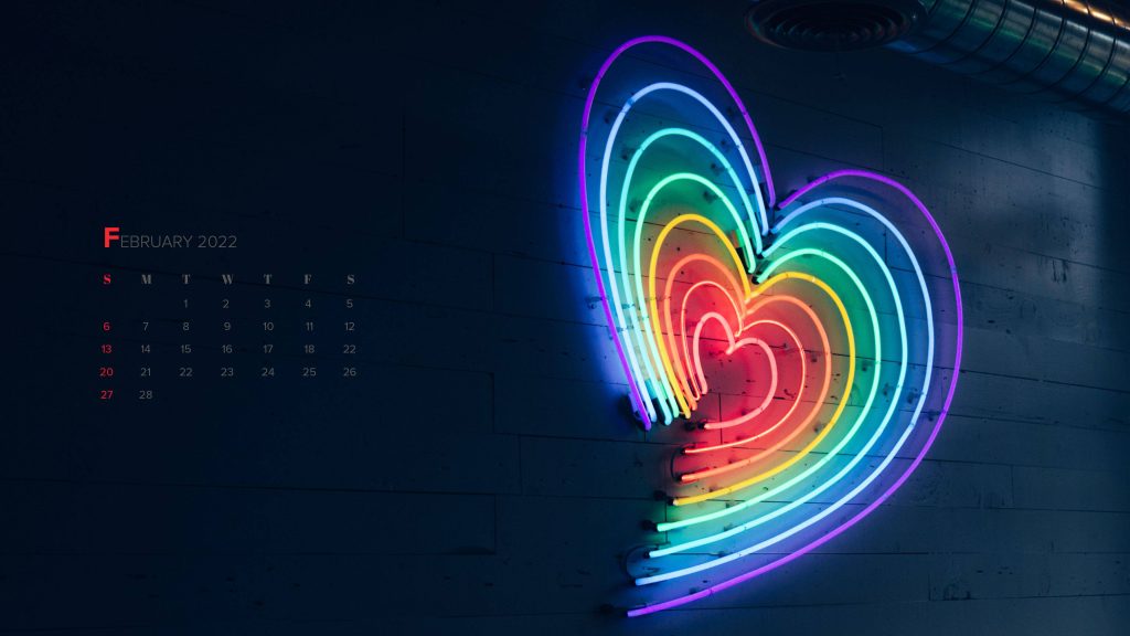 February 2022 calendar wallpaper with glowing neon rainbow heart on dark textured wall background