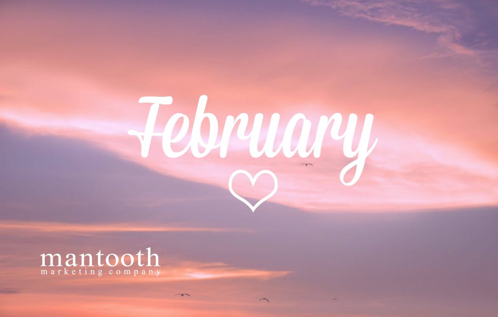 February wallpaper with pink lavender sunset sky white script and heart over bird-filled horizon