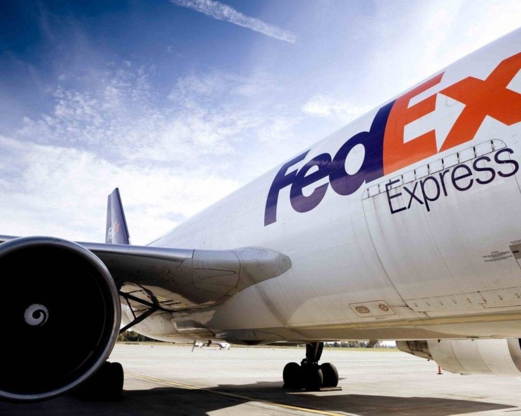 FedEx Express cargo plane low angle side view detailed fuselage engine on airport tarmac wallpaper