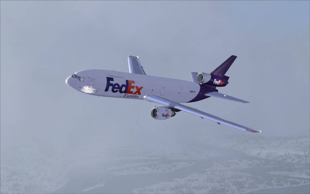 FedEx MD-11 freighter flying over snowy winter landscape digital flight simulator wallpaper